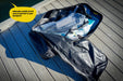 Inflatable paddle board and accessories in a backpack on a wooden deck