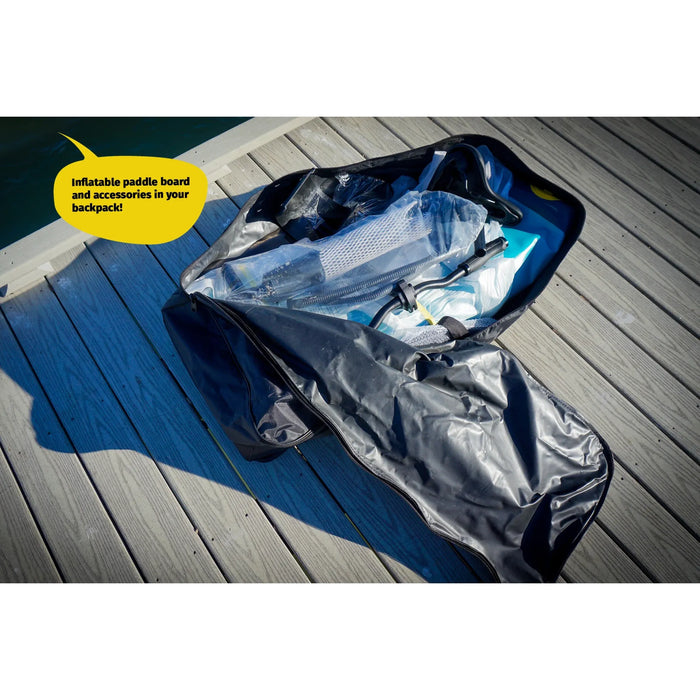 Inflatable paddle board and accessories in a backpack on a wooden deck