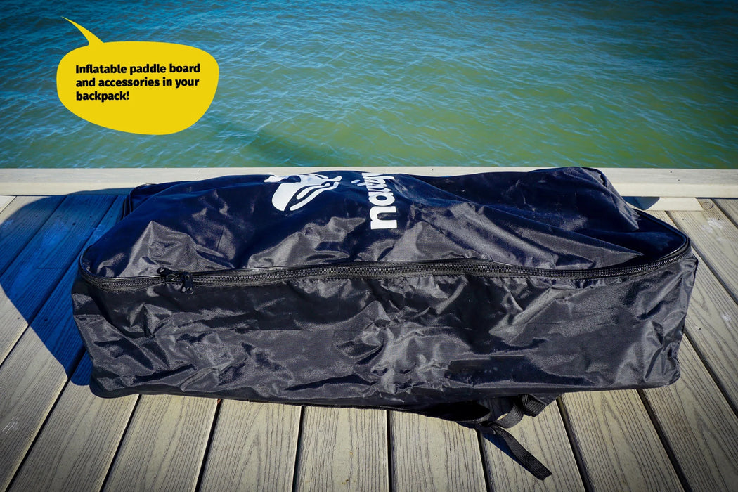 Blue inflatable paddle board bag with a visible brand logo on a wooden dock by water.