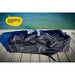 Blue inflatable paddle board bag with a visible brand logo on a wooden dock by water.