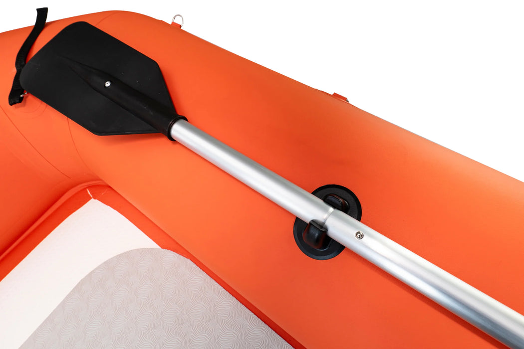 Orange inflatable kayak with a black paddle on a white background