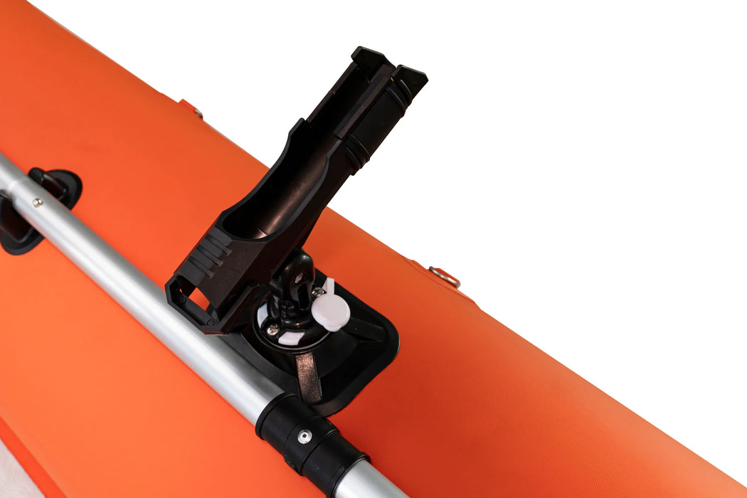 Close-up of a black clamp attached to an orange surface with a white background