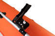 Close-up of a black clamp attached to an orange surface with a white background