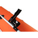 Close-up of a black clamp attached to an orange surface with a white background