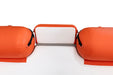 Orange inflatable sleeping pad on a white background