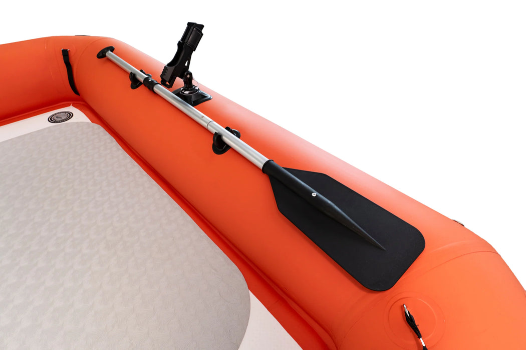 Orange inflatable boat with a black paddle attached on a white background
