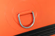 Close-up of an orange luggage handle with a metal ring