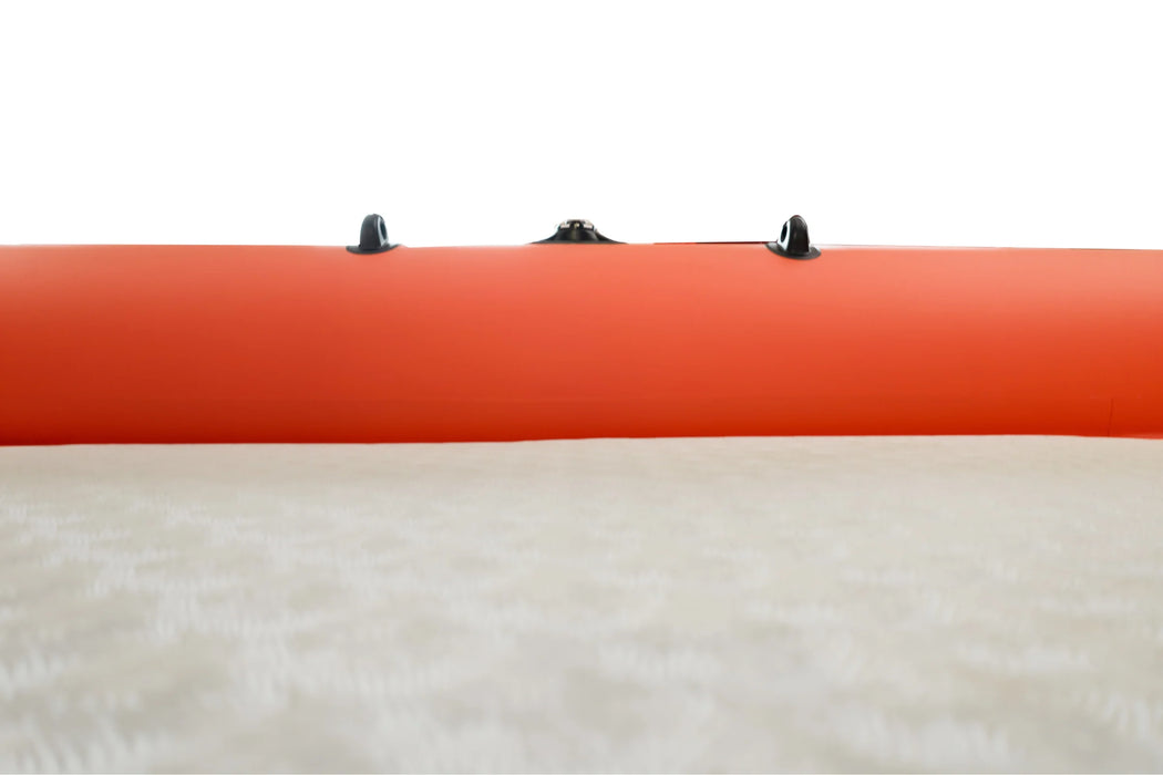 Close-up of an orange kayak with black straps on a white background