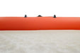 Close-up of an orange kayak with black straps on a white background