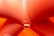 Close-up of a red fabric bow with a metal ring in the center.