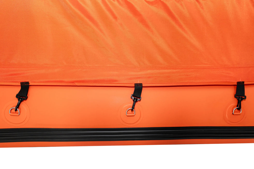 Close-up of an orange bag with black zippers and hooks on a white background