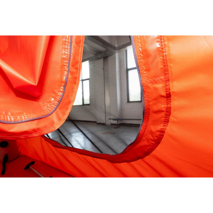 Close-up of an orange inflatable boat with a white interior, showing the floor and side walls.