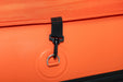 Close-up of an orange bag with a black strap and metal ring on a matching orange background.
