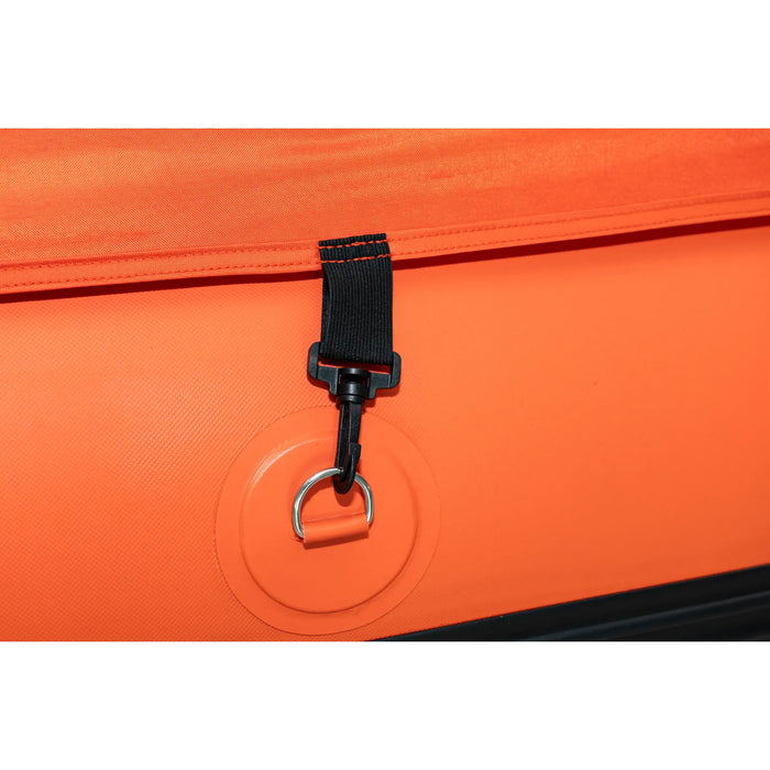 Close-up of an orange bag with a black strap and metal ring on a matching orange background.