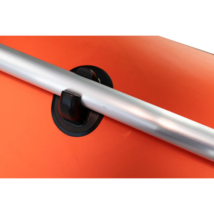 Close-up of a metal bar with a black clip on an orange background