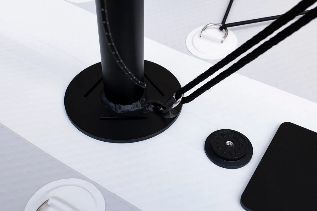 Black adjustable desk lamp on a white surface with a smartphone and mouse pad.