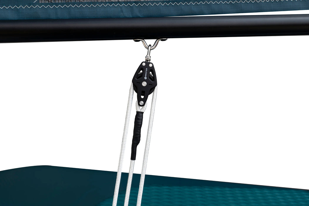 Close-up of a black pulley system attached to a blue canopy.