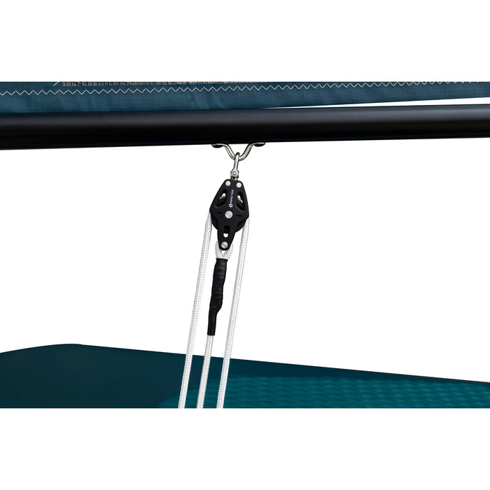 Close-up of a black pulley system attached to a blue canopy.