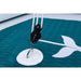 Close-up of a sailboat's rigging with a white hook on a teal sail.
