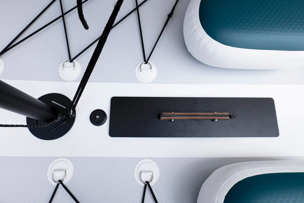 Close-up of a desk setup with a pen on a black mat, surrounded by office furniture.
