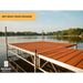 Wooden dock on a lake with trees in the background, branded with Patriot Docks.