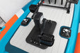 Close-up of a black joystick and control panel on an inflatable boat with orange and blue accents.