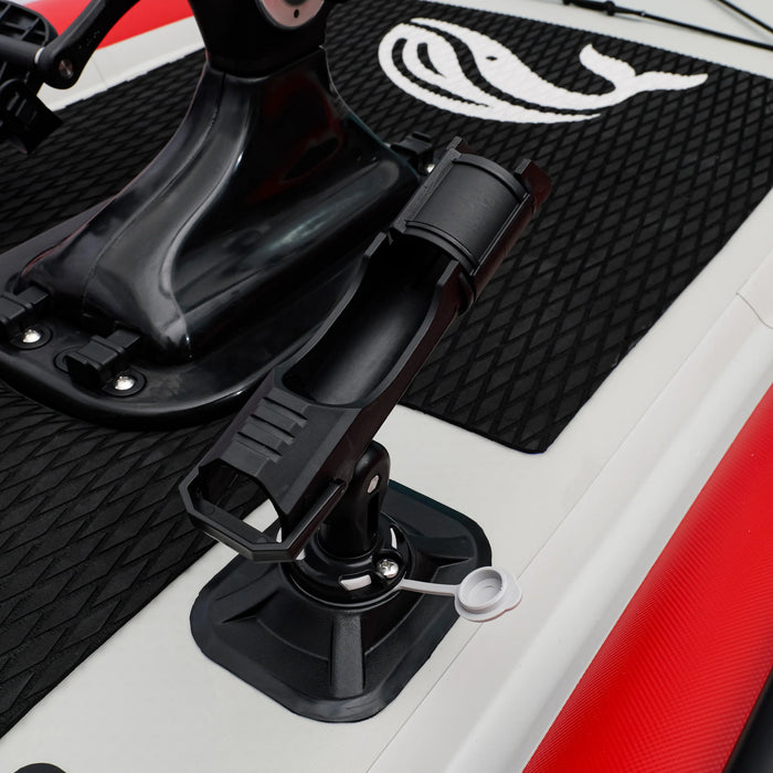 Close-up of a black motorcycle foot peg on a red and white motorcycle.