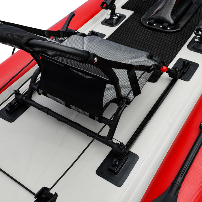Black kayak seat mounted on a red and white kayak