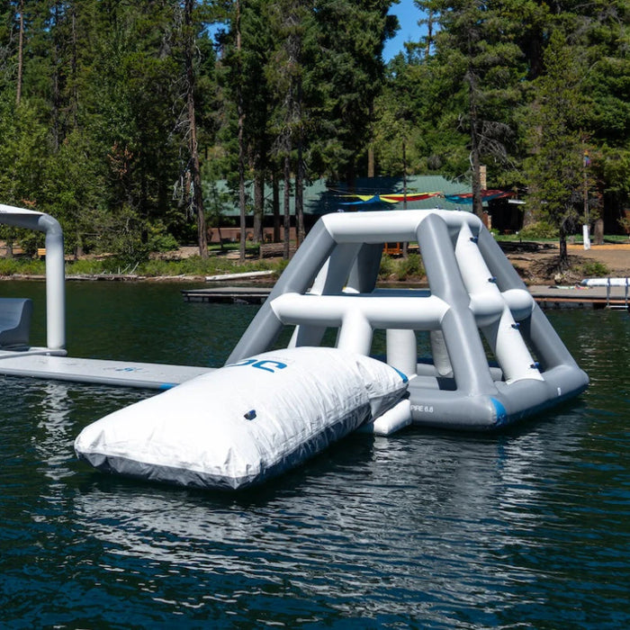 Inflatable water slide on a lake with trees in the background