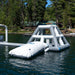 Inflatable water slide on a lake with trees in the background